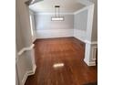 Dining room with hardwood floors, modern lighting, and neutral walls, creating an elegant atmosphere at 2571 Royston Dr, Duluth, GA 30097