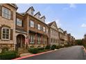 Beautiful row of brick townhomes with well-maintained landscaping and inviting curb appeal at 2368 Saint Davids Nw Sq # 4, Kennesaw, GA 30152