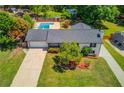 Aerial view showcasing the home, long driveway, and inviting swimming pool area at 3625 Knoll Crest Trl, Buford, GA 30519