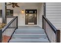 Inviting front porch with detailed railings and an ornate front door at 3625 Knoll Crest Trl, Buford, GA 30519