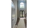 Grand foyer features soaring ceilings, large arched windows, and a glimpse of the staircase at 8013 White Stone Blvd, Douglasville, GA 30135