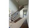 Elegant staircase with dark wood railings and white risers leads to the upper level at 8013 White Stone Blvd, Douglasville, GA 30135