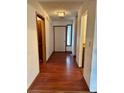 Hallway with wood floors leads to front door; features side window and closet at 9033 Greystone Rd, Jonesboro, GA 30238