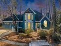 Charming blue two-story home featuring a manicured front yard and a two car garage at 3017 Lana Ln, Marietta, GA 30066