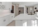 Spacious, sunlit kitchen with a central island, modern appliances, quartz countertops, and white cabinetry at 3017 Lana Ln, Marietta, GA 30066