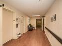 Hallway featuring an elevator on one side and a view down a long hallway with a sitting area at 475 Mount Vernon Ne Hwy # A-102, Sandy Springs, GA 30328