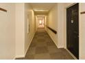 Long hallway with doors on the right with beige walls and carpeted floor at 475 Mount Vernon Ne Hwy # A-102, Sandy Springs, GA 30328