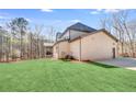 Rear view of home highlighting large yard and neutral brick exterior at 603 Old Peachtree Ne Rd, Lawrenceville, GA 30043