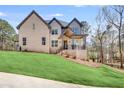 Charming two-story home with a welcoming front porch and lush green lawn at 603 Old Peachtree Ne Rd, Lawrenceville, GA 30043