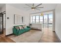 Bright living room boasts a green sofa, city views, large windows, and modern decor at 3060 Pharr Court North Nw # 619, Atlanta, GA 30305