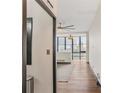 Living room featuring hardwood floors, ceiling fan, modern lighting, and city views at 3060 Pharr Court North Nw # 619, Atlanta, GA 30305