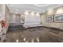Stylish lobby with marble walls, decorative screen, modern seating, and art at 3060 Pharr Court North Nw # 619, Atlanta, GA 30305