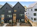 A close view shows these newly constructed townhomes with black brick and modern architectural features at 654 Soul Aly, Alpharetta, GA 30009