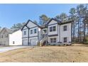 Charming two-story home with a two-car garage, modern design, and well-maintained lawn at 3278 Greenhill Dr, Villa Rica, GA 30180