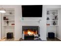 Cozy living room featuring a fireplace with built-in shelves and modern decor at 223 Smokerise Se Cir, Marietta, GA 30067