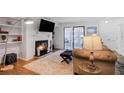 Inviting living room with a fireplace, comfortable seating, and sliding glass doors at 223 Smokerise Se Cir, Marietta, GA 30067