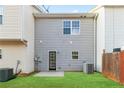 A backyard features a well-maintained lawn and a door to the home at 129 Prospect Path, Hiram, GA 30141