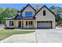 Stunning two-story home with a light brick facade, dark trim, and a spacious driveway and lush landscaping at 270 New Hope Rd, Lawrenceville, GA 30046