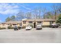 Apartment complex featuring balconies and ample parking space on a partly cloudy day at 3175 Seven Pines Ct # 207, Atlanta, GA 30339