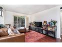 Inviting living room featuring a comfortable leather sectional and view to the outside at 3175 Seven Pines Ct # 207, Atlanta, GA 30339