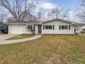 Charming single-story home featuring a white exterior, attached garage, and a well-maintained front yard at 1665 Ridgeview Nw Dr, Conyers, GA 30012
