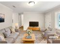 Bright living room with neutral walls, two couches and chairs, and a large rug; a perfect space for relaxing and entertaining at 1665 Ridgeview Nw Dr, Conyers, GA 30012