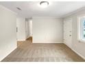 Bright living room with neutral walls and carpet; a perfect space for relaxing and entertaining at 1665 Ridgeview Nw Dr, Conyers, GA 30012