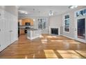 Open-concept living room with fireplace, hardwood floors, and adjacent kitchen at 4879 Pinnacle Dr, Stone Mountain, GA 30088