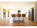 Bright, open kitchen featuring sleek stainless-steel appliances, white cabinets and a breakfast bar with seating at 900 King Rd, Jonesboro, GA 30236