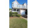 Inviting townhome exterior featuring a one-car garage and manicured front yard at 770 Parkway Rd, Union City, GA 30291