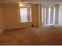 Bright carpeted living room featuring a window and sliding glass door at 770 Parkway Rd, Union City, GA 30291