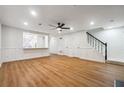 Living room with a ceiling fan, wood floors, and a view into the kitchen at 2977 Heritage Villas Dr, Lithonia, GA 30038
