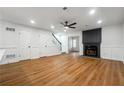 Bright living room with a fireplace, ceiling fan, and beautiful wood flooring at 2977 Heritage Villas Dr, Lithonia, GA 30038