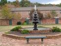 Beautiful courtyard with a tiered fountain and bench surrounded by well-maintained landscaping at 3125 Colonial Way # H, Atlanta, GA 30341