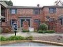Two-story brick townhouse featuring well-maintained landscaping in a suburban setting at 3125 Colonial Way # H, Atlanta, GA 30341