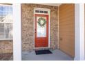 Close-up of a welcoming red front door with glass panels and a charming decorative wreath at 1514 Park Grove Dr, Lawrenceville, GA 30046