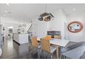 Bright dining area with modern lighting, hardwood floors, and an open floor plan to the kitchen at 1756 Morningtide Ne Ln, Atlanta, GA 30324
