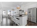 Modern kitchen with stainless steel appliances, oversized island with seating, and hardwood floors at 1756 Morningtide Ne Ln, Atlanta, GA 30324
