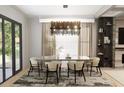 Elegant dining room featuring a modern chandelier, neutral-toned decor, and large windows for natural light at 4250 Carmain Ne Dr, Atlanta, GA 30342