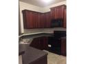 Cozy kitchen featuring wood cabinets, sleek black appliances, and granite countertops at 266 Valley Xing, Canton, GA 30114