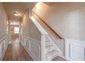 Hallway featuring wood floors, paneled walls, staircase, and natural light at 3782 Chattahoochee Summit Se Dr, Atlanta, GA 30339