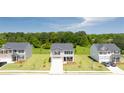 Exterior view of a new neighborhood showcasing several two-story homes with spacious front lawns at 300 Halibut Circle Cir, Covington, GA 30016