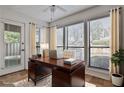 Well-lit office with large windows and a dark wood desk at 313 River Mill Cir # 313, Roswell, GA 30075