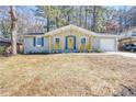 Charming ranch home with yellow porch railing, light gray brick, and cheerful yellow front door at 6058 Ledgewood Dr, Forest Park, GA 30297