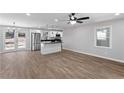 Open concept living room and kitchen with hardwood floors and stainless steel appliances at 6058 Ledgewood Dr, Forest Park, GA 30297