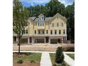 Charming yellow townhomes, each featuring attached garages and inviting curb appeal at 1977 American Way # 30, Kennesaw, GA 30144