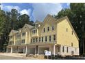 Modern townhome with bright siding, multiple windows, and attached garage, offering comfort and convenience at 1977 American Way # 30, Kennesaw, GA 30144