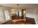 Open living room with hardwood floors and access to the kitchen and other living areas at 465 Salem Woods Se Dr, Marietta, GA 30067