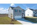 Beautiful two-story home with a two-car garage and well-maintained lawn in a residential neighborhood at 8597 Secretariat Dr, Lithonia, GA 30058
