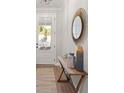 Inviting entryway with stylish mirror, decorative vases and bench offering a warm welcome at 1983 American Way # 27, Kennesaw, GA 30144